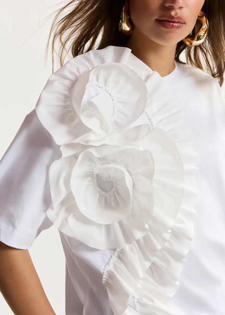 Shirt Essentiel Antwerp Jidole Shirt with Bug in weiß. Das T-Shirt ist aus 100% Baumwolle gefertigt und hat eine lässige Silhouette. Eine große und kaskadenförmige Rüsche an der Vorderseite erzeugt eine schöne Blumenrüsche.