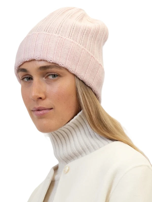 Beanie Laura von Anna v Berg. Diese hochwertige Beanie aus 100 % Kaschmir begeistert mit ihrem besonders weichen Griff und sorgt für ein angenehm kuscheliges Tragegefühl. Das zeitlose Rippstrick-Design macht sie zu einem stilvollen Begleiter für die kühlen Tage. Ein hochwertiges Accessoire, das Wärme und lässige Eleganz perfekt miteinander verbindet