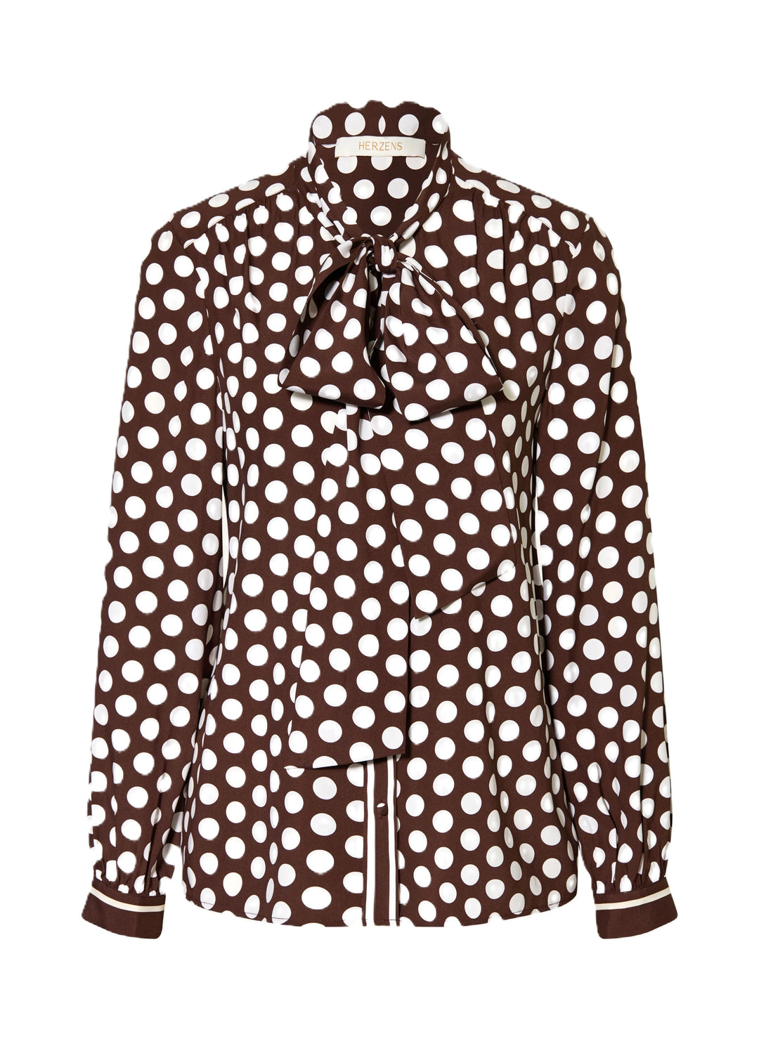 Bluse Herzens. Schöne feminine Bluse mit Pünktchenmuster in braun weiß. Die Bluse hat eine Schluppe und schöne überzogene Knöpfe. Auch an den Manschetten sind die Knöpfe farblich passend überzogen. Die Ärmel sind lang und die Form gerade. An der Vorderseite sind leichte Falten eingearbeitet.