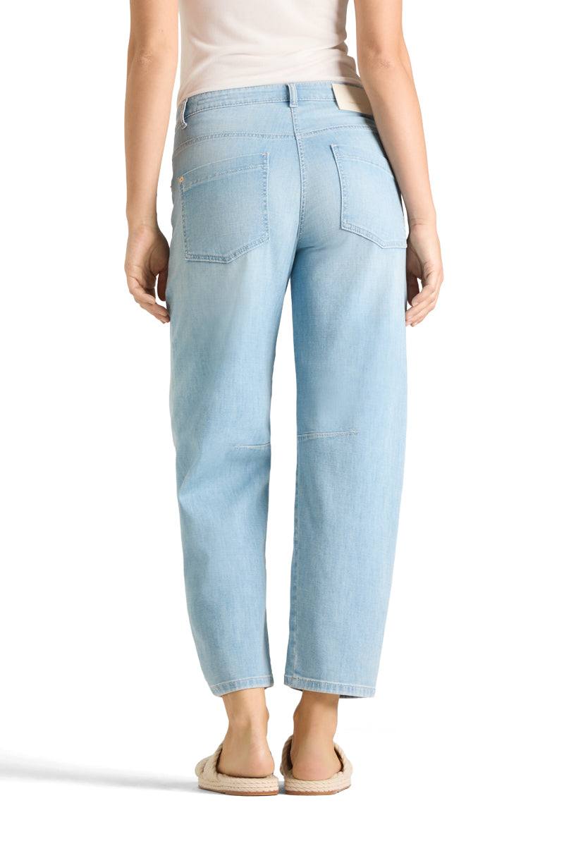 Jeans Cambio Ocean. Coole Jeans von Cambio in einem helleren Blauton. Die Waschung ist leicht verwaschen. Die Jeans hat zwei große Taschen auf der Vorderseite, einen Zip und einen Knopfverschluss. Die Jeans ist leicht konisch geschnitten, das heißt, dass sie nach unten gehend etwas schmäler wird. Das Bein ist verkürzt. Zwei Nähte an den Knien verstärken den modernen Look.