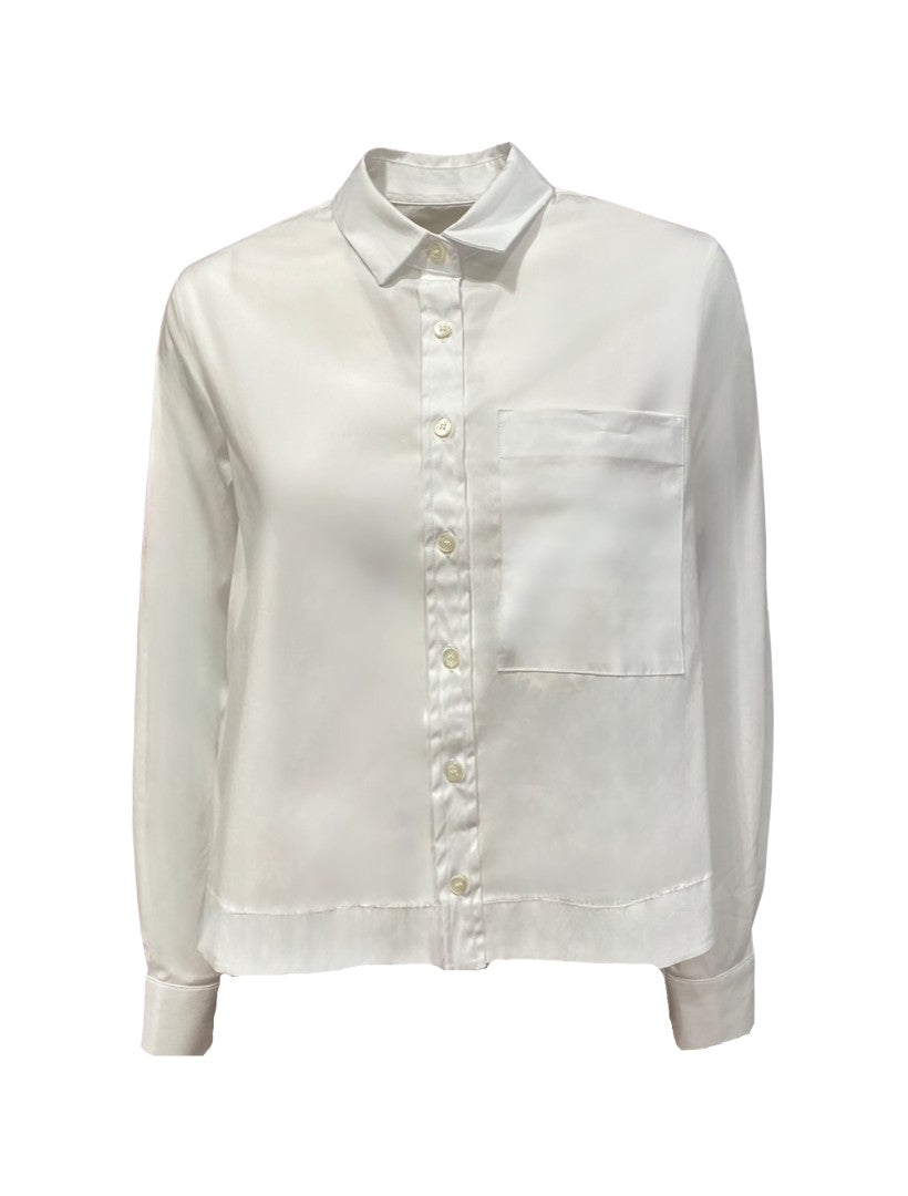 Hemd The White Shirt in weiß. Diese Hemdbluse hat eine verkürzte Länge und fällt größengerecht aus. Sie hat einen klassischen Hemdkragen und eine durchgehende Knopfleiste. Ein Highlight sind die große aufgesetzte Brusttasche und die am Rücken überlappende Falte.