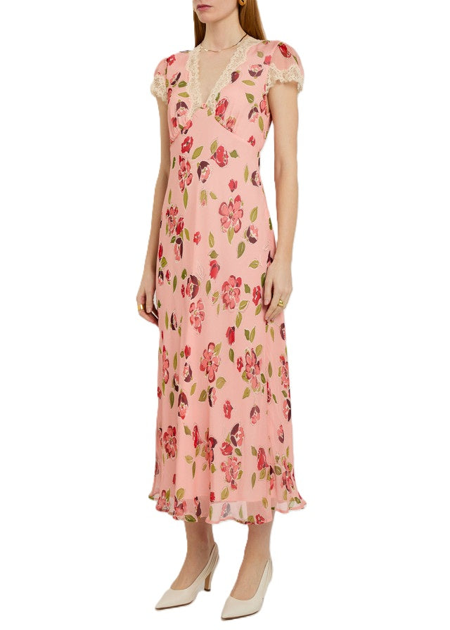 Kleid Rixo. Wunderschönes Kleid mit Blumenprint. Am Ausschnitt und am Ärmel ist das Kleid mit Spitze verziert. Am V-Ausschnitt wurde noch eine hübsche zarte Rose plaziert. Das Kleid hat einen kleinen Gürtel und ist lang geschnitten.