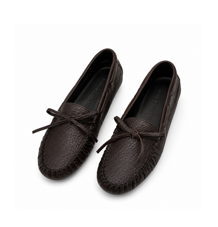 Ein dunkelbrauner Lederschuh von der Marke Kennel und Schmenger. Der Loafer hat dekorative Nähte und eine Schleife vorne. Er ist dunkelbraun.