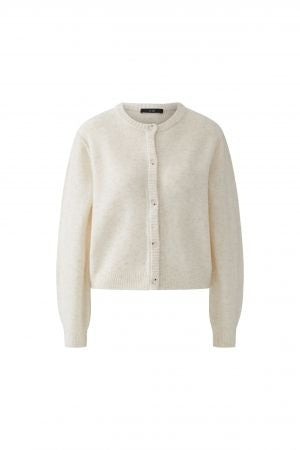 Strickjacke Oui Ilaya in ecru. Kuschelig weiche Garnmischung mit glatt gestrickter Oberfläche und markanten Outside Seams. Lässiger, leicht verkürzter Schnitt mit zurückversetzter Schulternaht. Rundhalsausschnitt, lange Ärmel und Knopfleiste mit Knöpfen in Hornoptik.